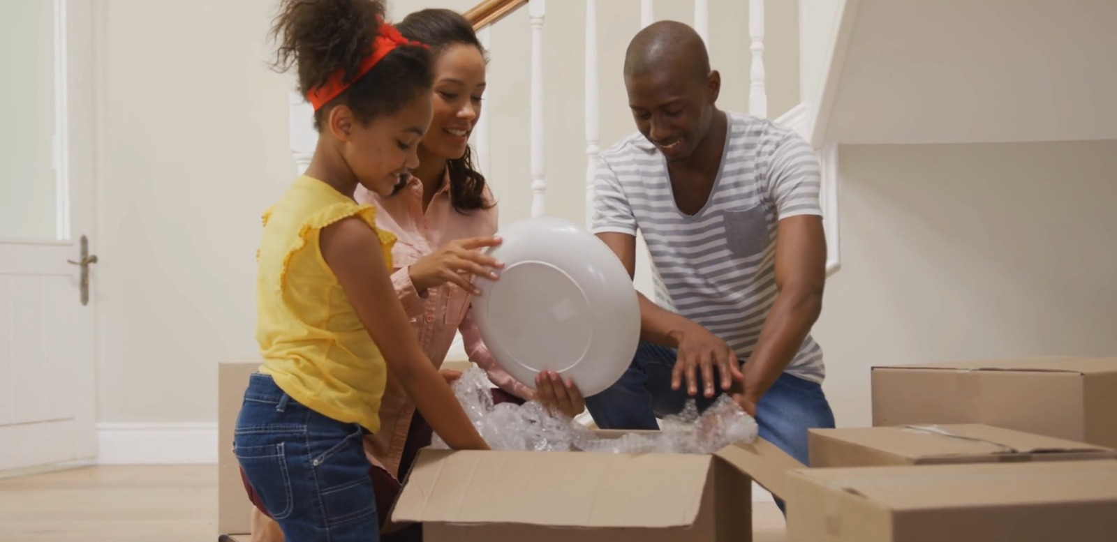 Happy family unpacking after their move